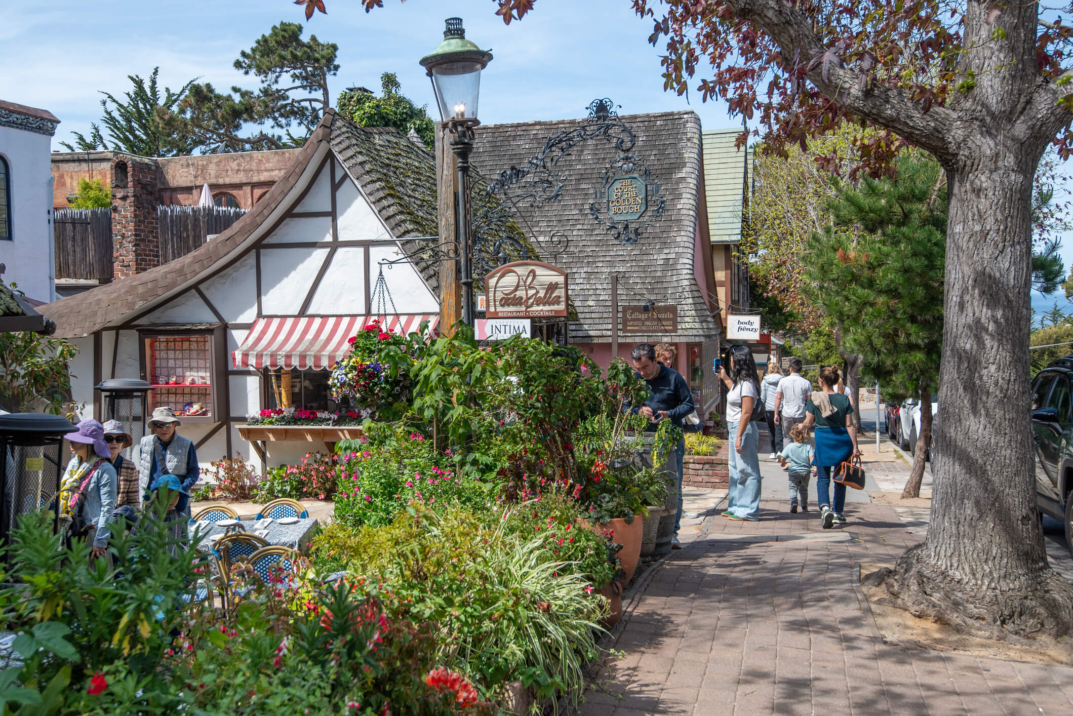 Carmel, CA. Ocean Street in Carmel-by-the-Sea, showing tourists and a quaint European-style house.