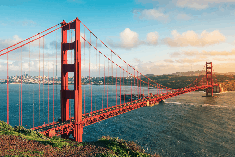 The Golden Gate Bridge, standing on the Golden Gate Strait in San Francisco, California, USA, stretches across the bay at sunset.